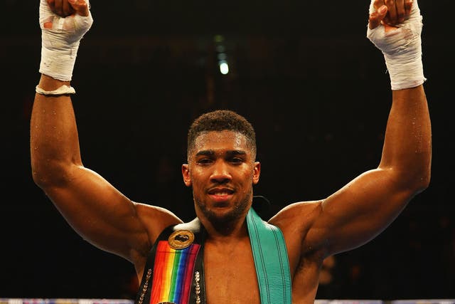 Anthony Joshua celebrates his victory over Dillian Whyte