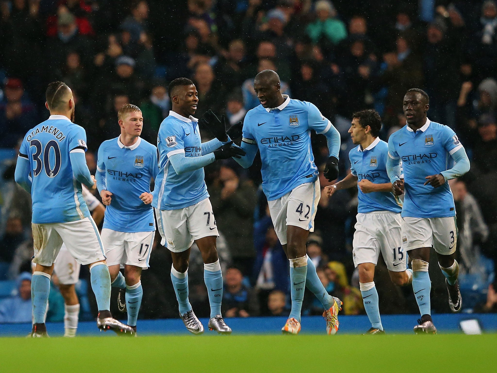 Yaya Toure is congratulated on scoring for Manchester City
