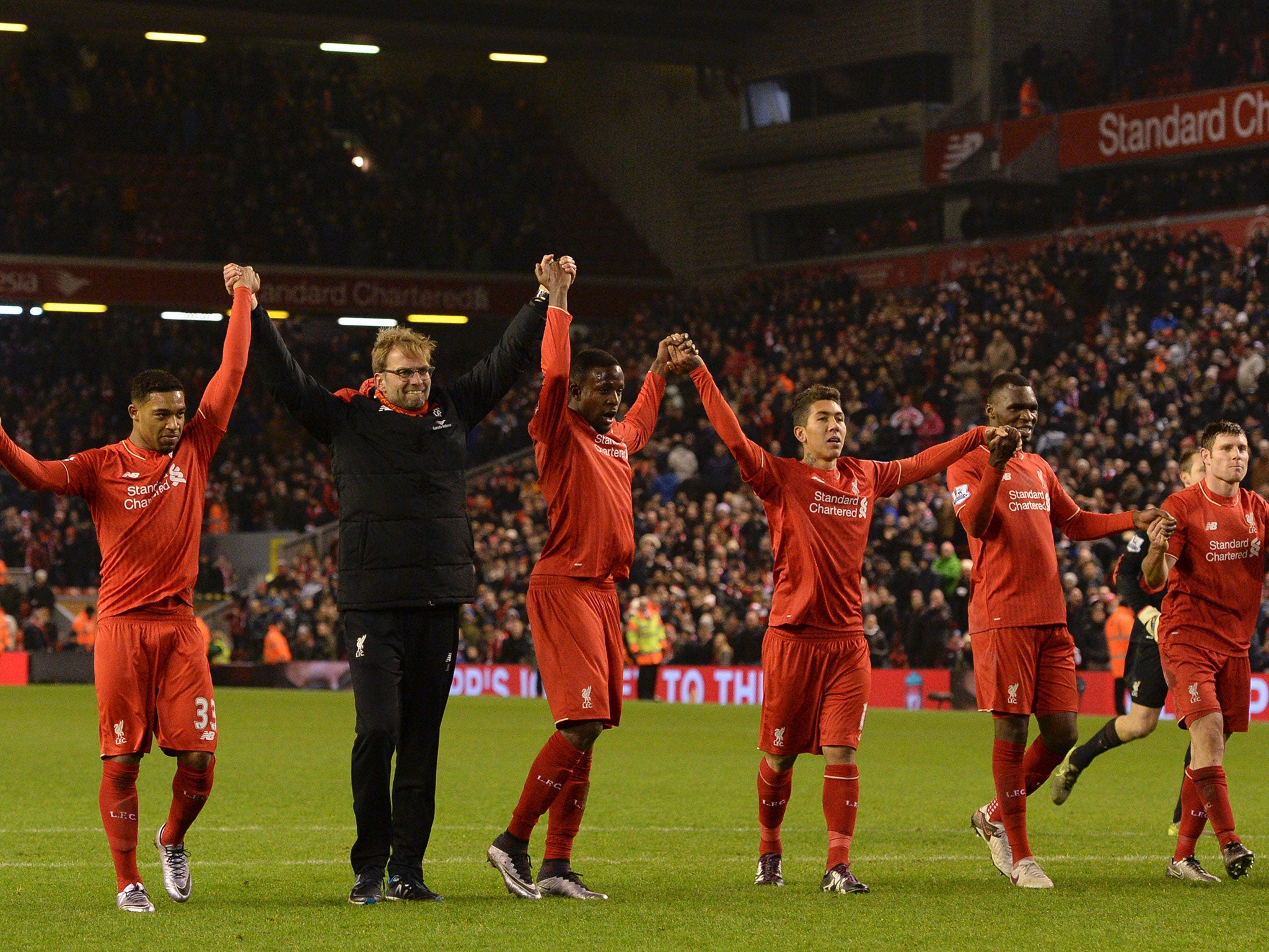 Jurgen Klopp leads his Liverpool side in acknowledging the fans after his side's 2-2 draw with West Brom