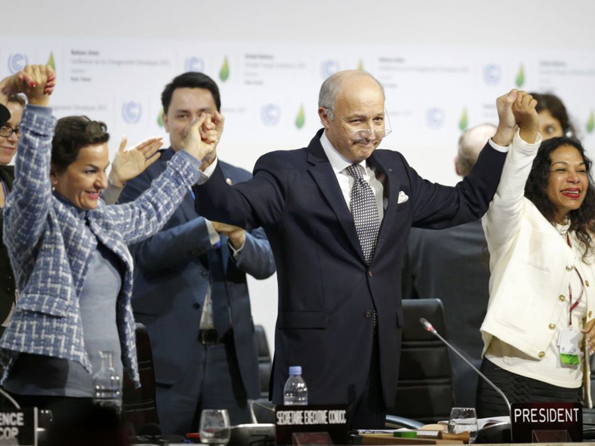 &#13;
Conference leader Laurent Fabius, centre, welcomes the global climate change agreement &#13;