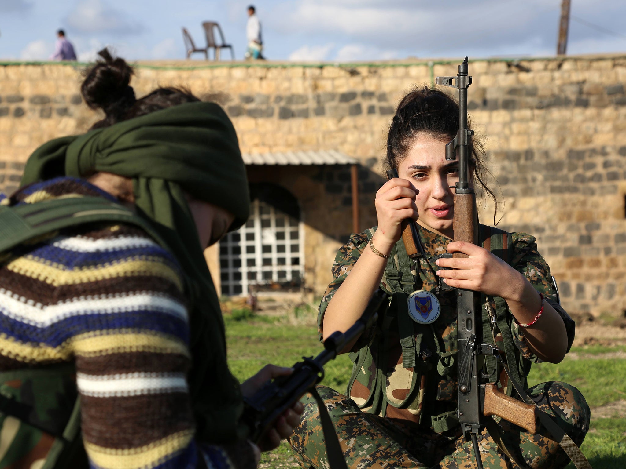 Ormia, member of the battalion called the "Female Protection Forces of the Land Between the Two Rivers" fighting Isis, loads her weapon during a training