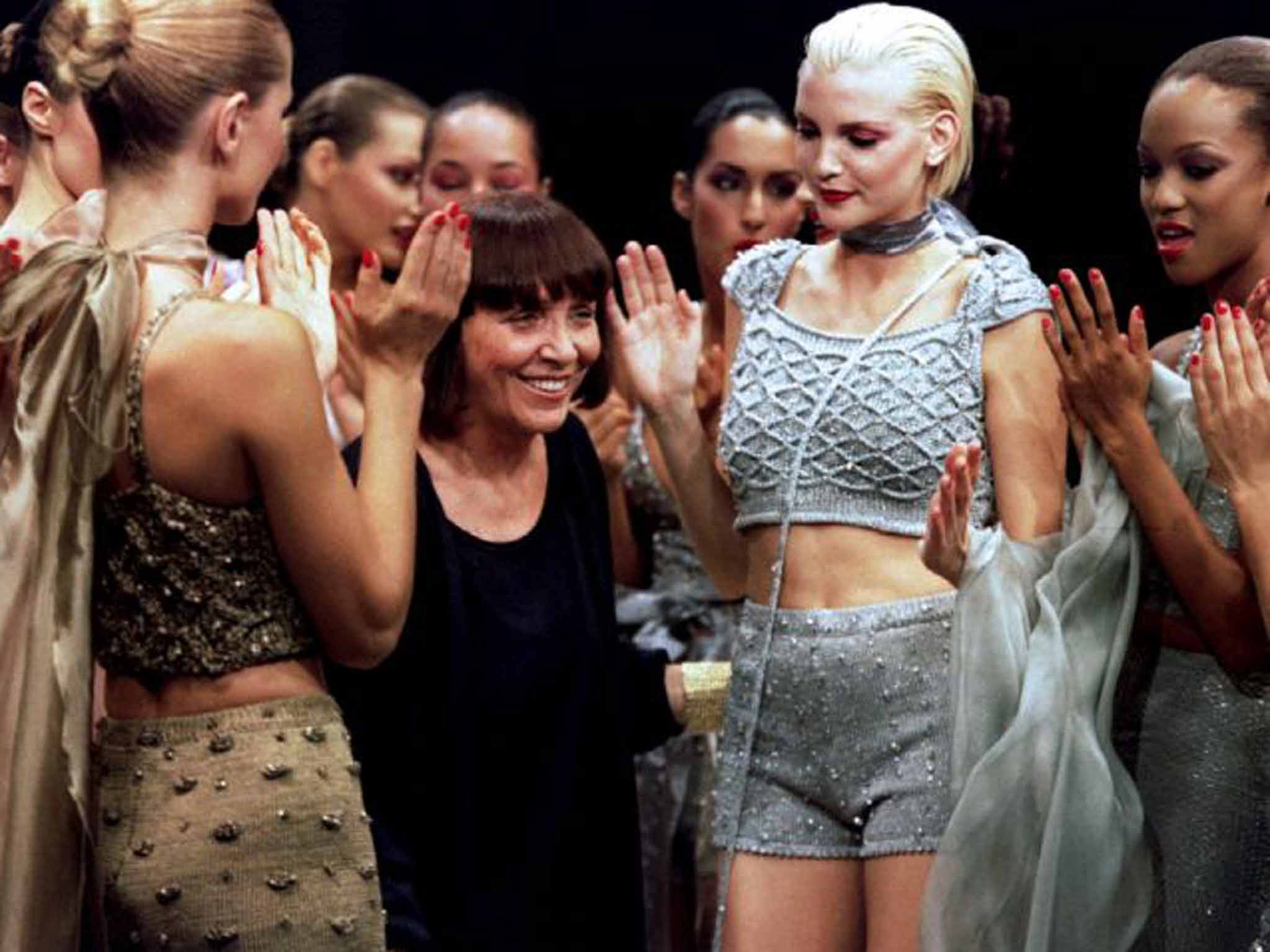 Mandelli basks in the applause ofher models on the catwalk in Milan in 1995