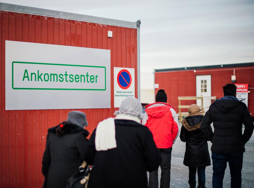 Refugees enter the arrival centre for refugees near the town on Kirkenes, northern Norway, close to the Russian - Norwegian border