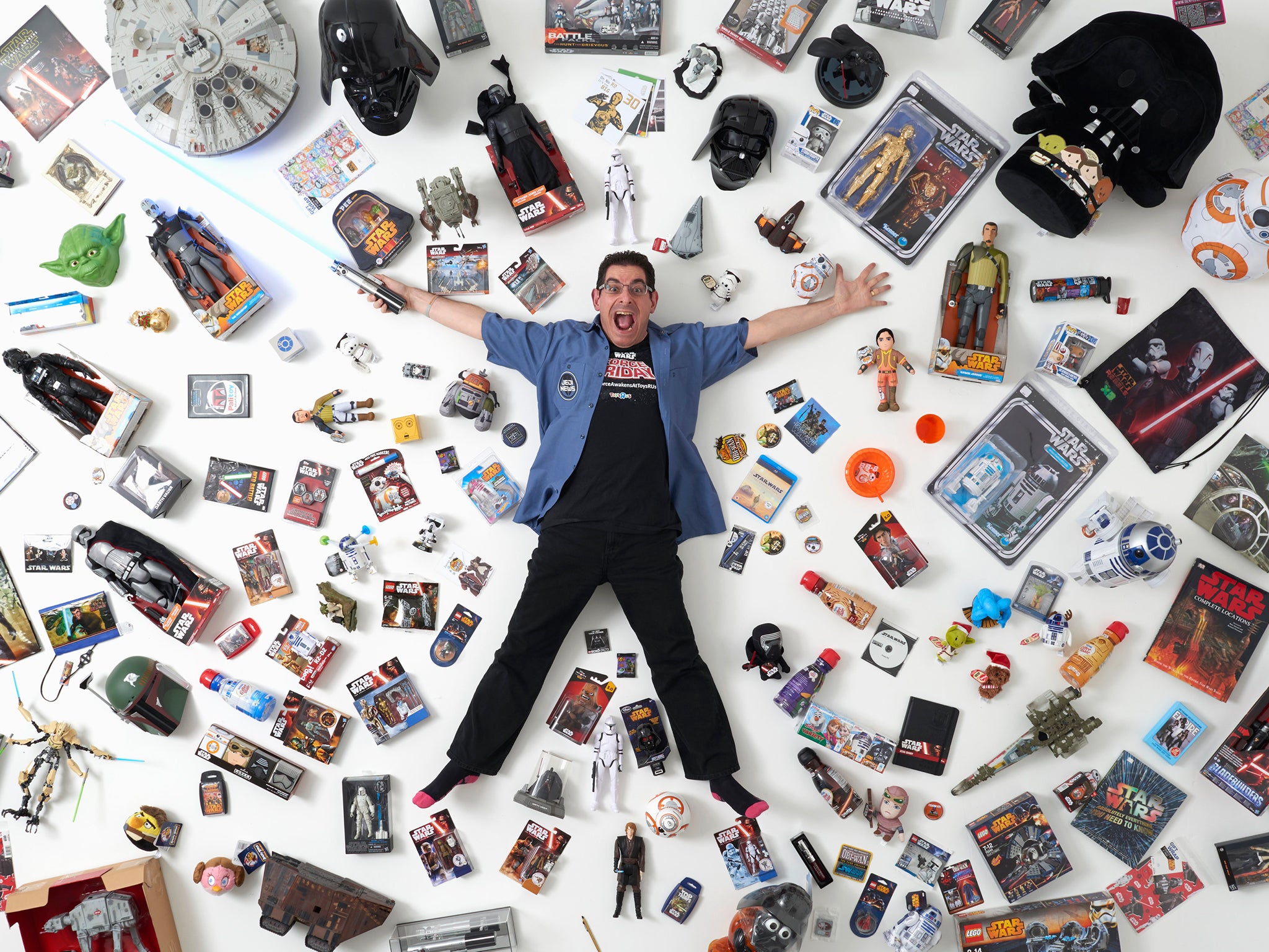 Star Wars collector James Burns, 44, poses for a photograph with some of his collection in London.