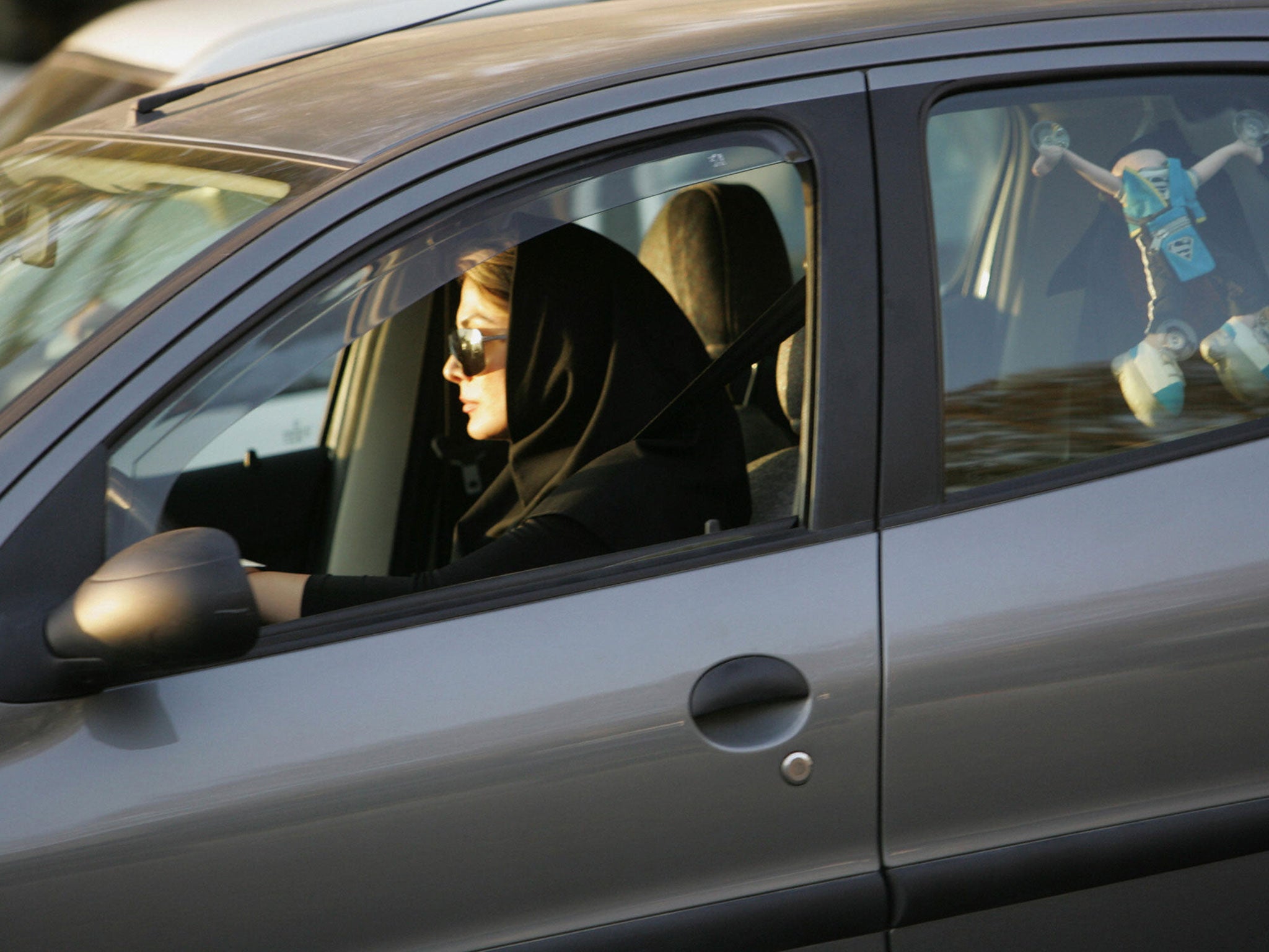 File: A woman drives her car in Iran