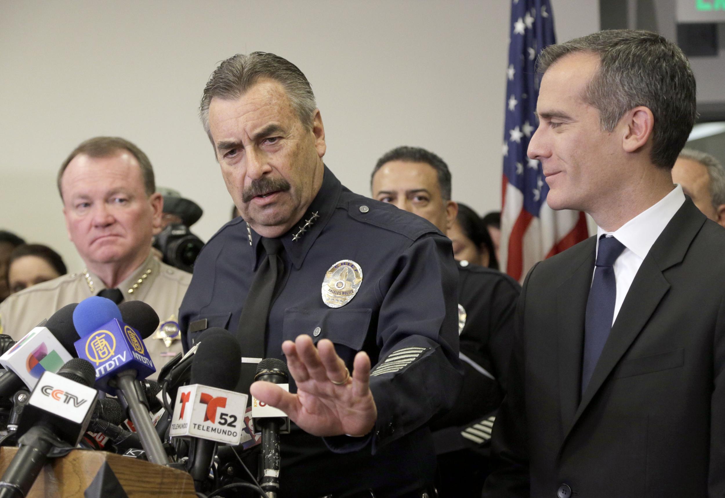 Charlie Beck, center, answers questions alongside Los Angeles Mayor Eric Garcetti. Nick Ut/Associated Press