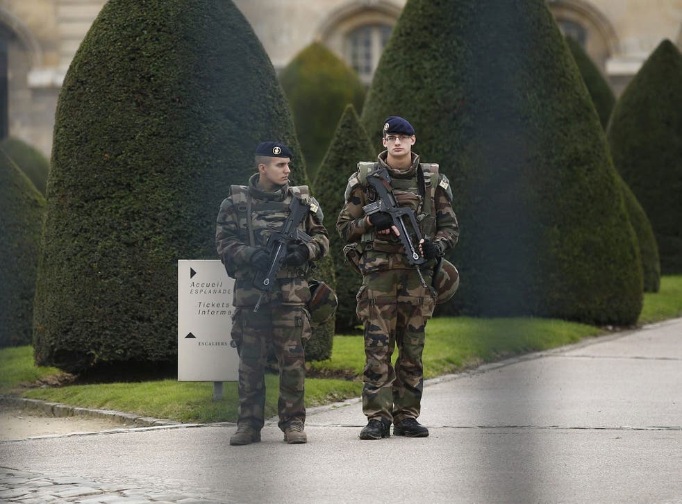 Armed military personell stand guard at the Invalides in Paris