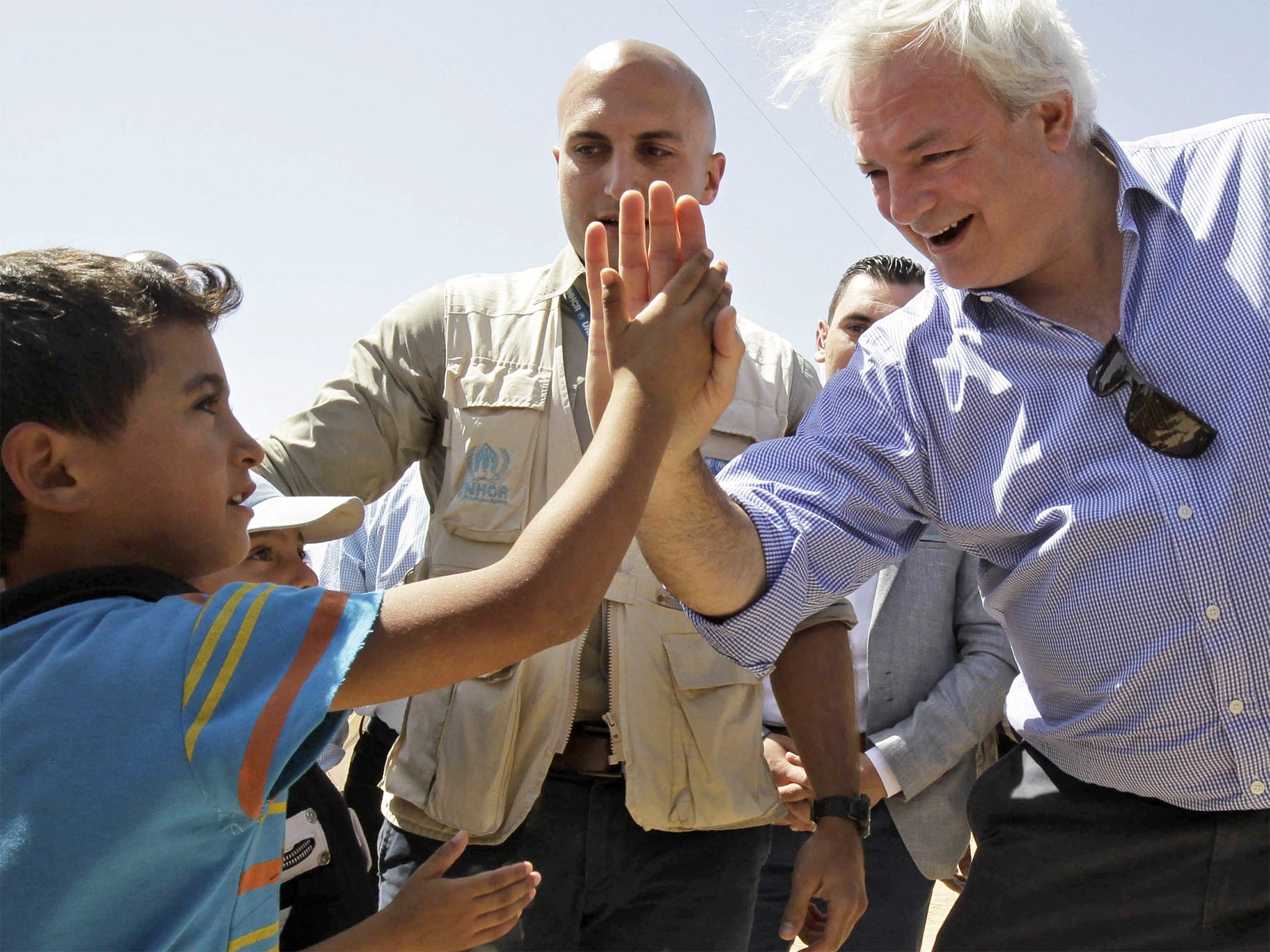 The UN’s humanitarian chief Stephen O’Brien greets a young Syrian refugee at the Zaatari camp in Jordan in September