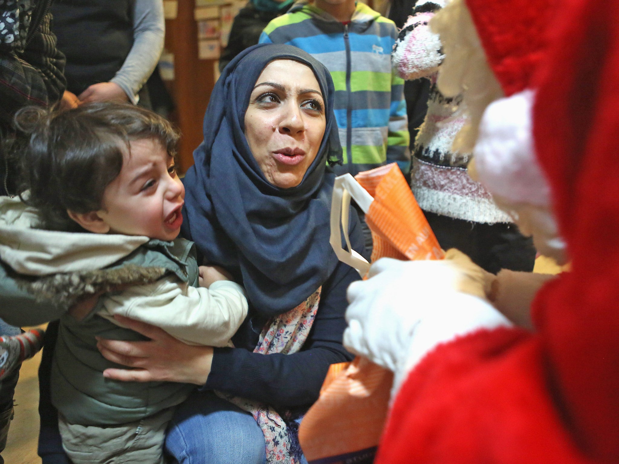 Syrian refugees meet Santa at a migrant shelter in Berlin