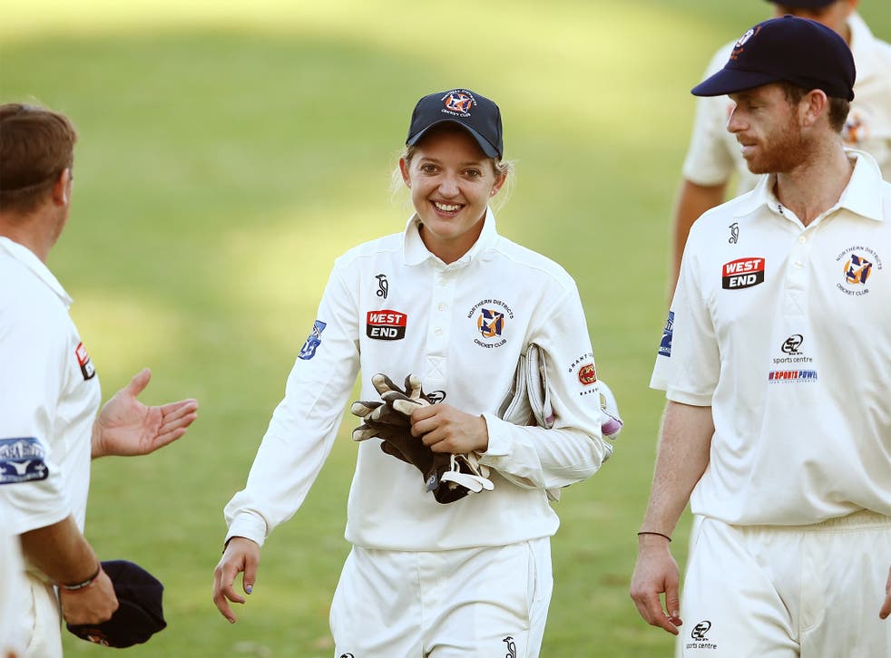 Sarah Taylor is congratulated by her Northern Districts team-mates after taking two catches on her debut
