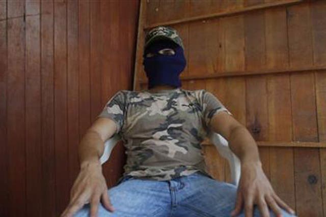 The man claiming to be responsible for kidnapping, torture and killing on behalf of a drug cartel speaks to the Associated Press in Guerrero state's Costa Grande region