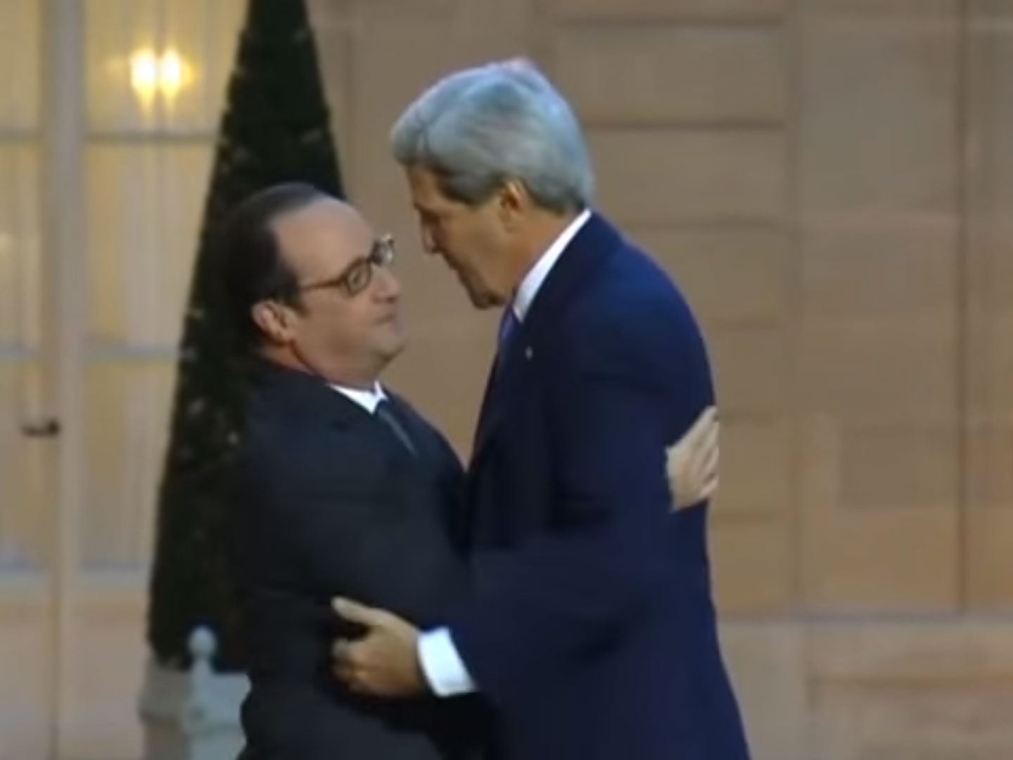 French President François Hollande, left, embraces Secretary of State John F. Kerry prior to a meeting at the Elysee Palace