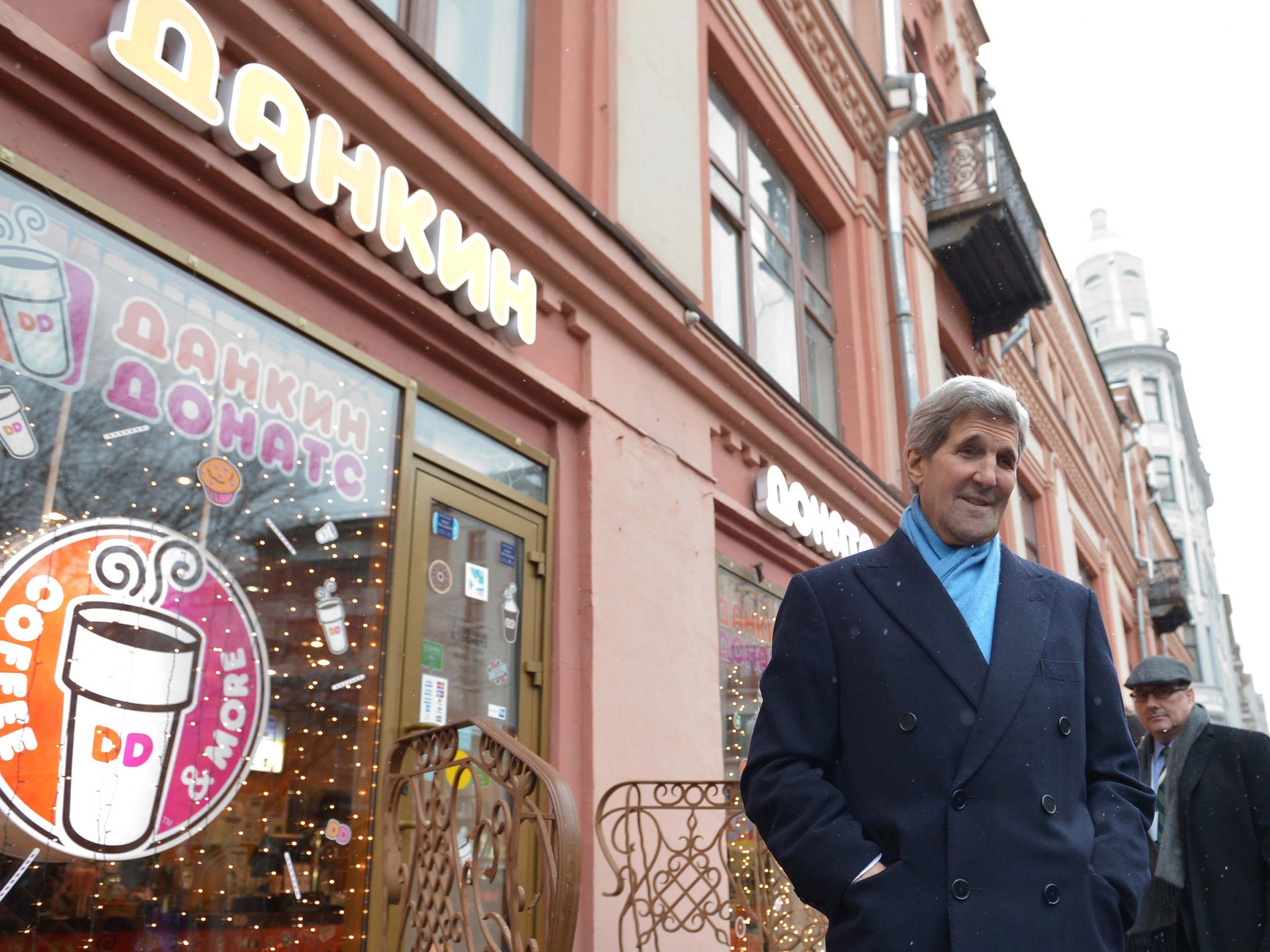 Secretary of State John F. Kerry stops in front of a Dunkin' Donuts while walking in Moscow