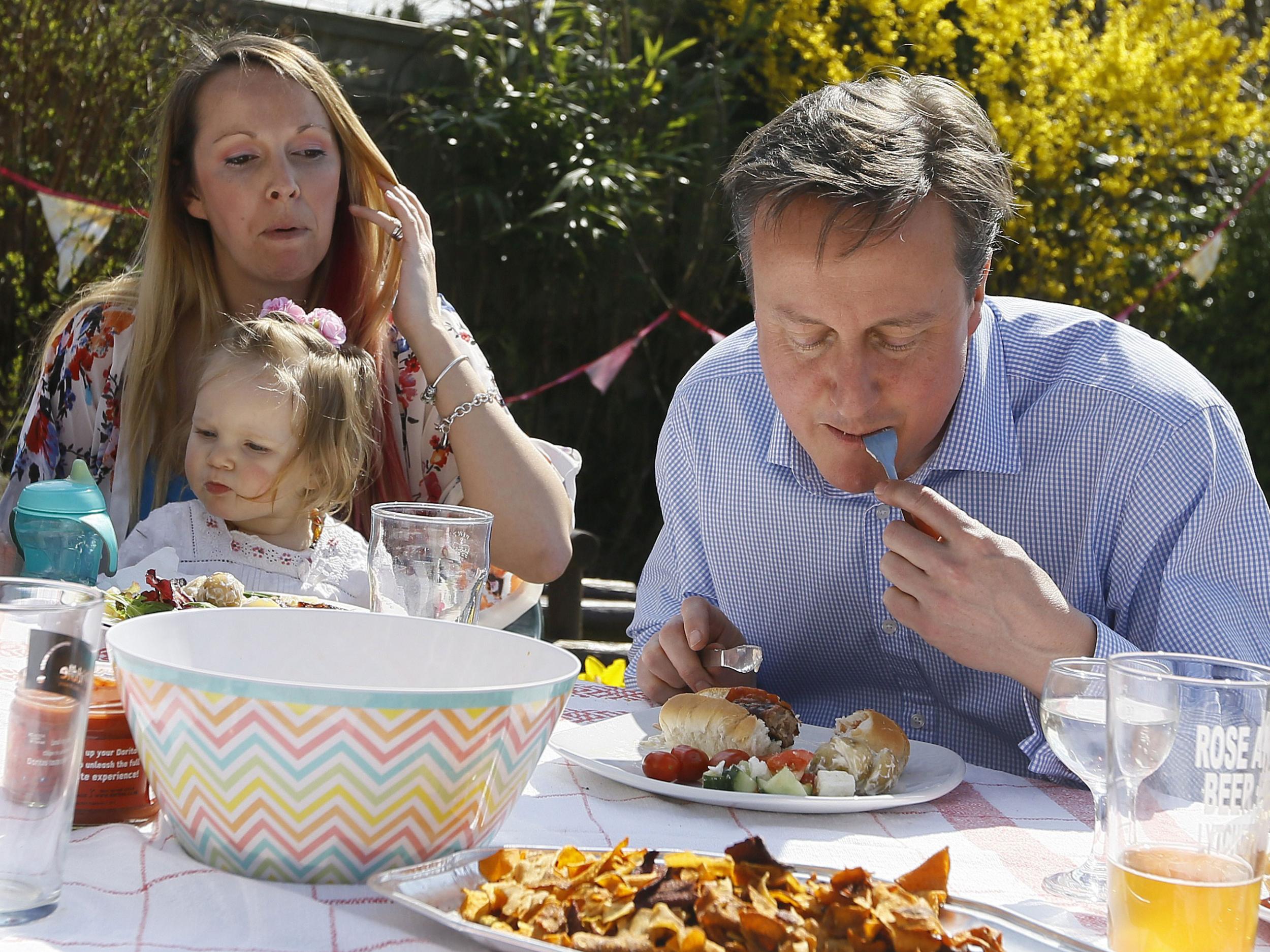 British Prime Minister David Cameron has a bite to eat with Lilli Docherty and her daughter, Dakota