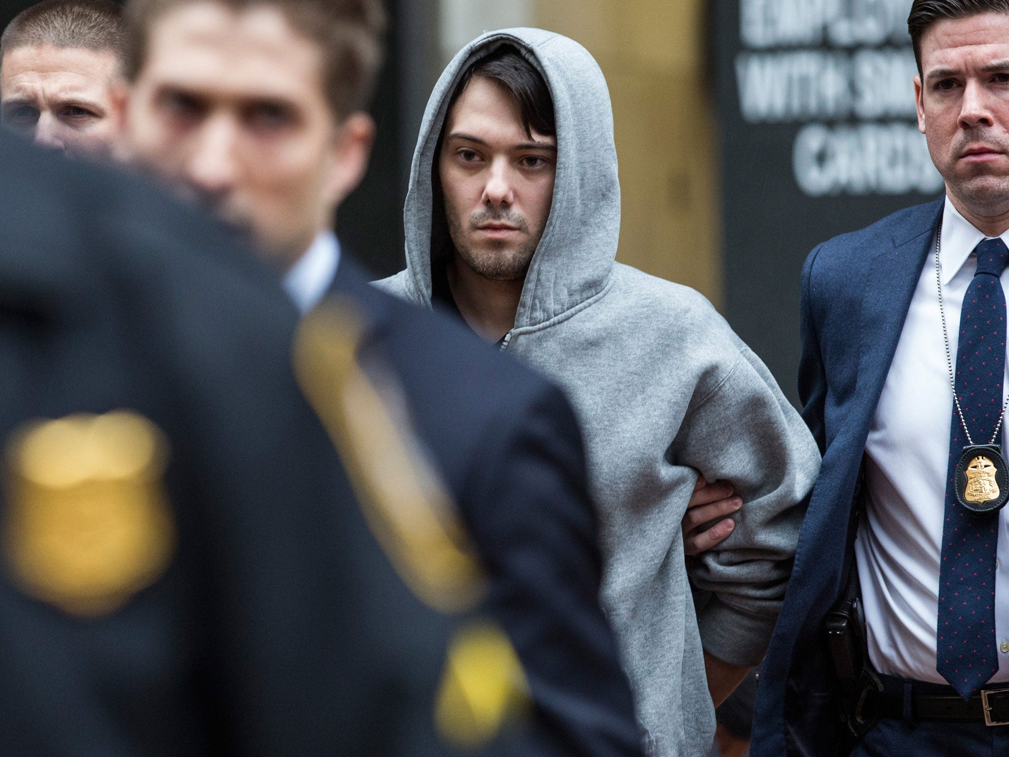 Martin Shkreli, the former CEO of Turing Pharmaceutical, being arrested for securities fraud