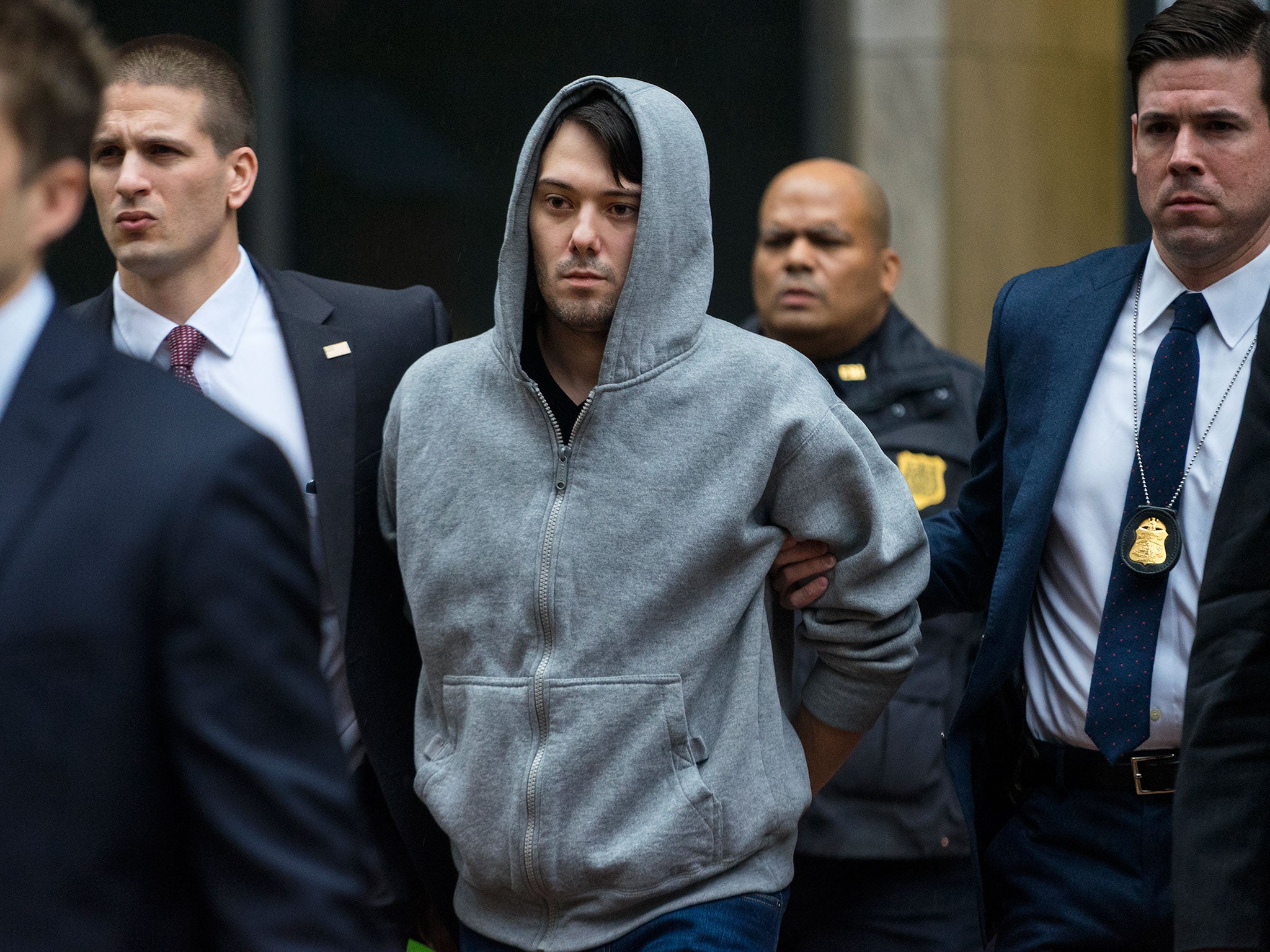 Martin Shkreli, the former hedge fund manager under fire for buying a pharmaceutical company and ratcheting up the price of a life-saving drug, is escorted by law enforcement agents in New York
