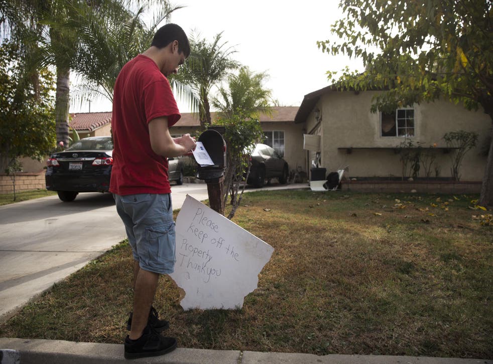 A brother of suspect Enrique Marquez collects his mail on Wednesday.