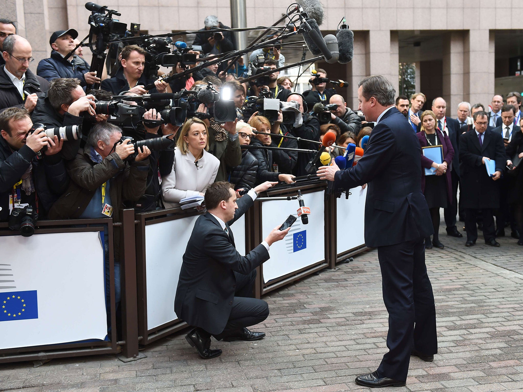 Britain's Prime minister David Cameron speaks to the media as he arrives at the European Council in Brussels