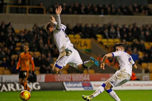 Chris Wood jumps out of the way to allow Sam Byram to score Leeds’ equaliser at Molineux