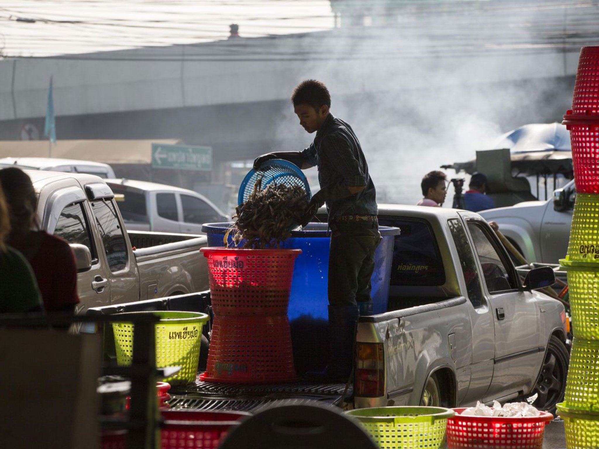 A worker unloads shrimp from the back of a pickup truck at a seafood market in Mahachai, Thailand. Thailand sends nearly half of its supply of shrimp to the US