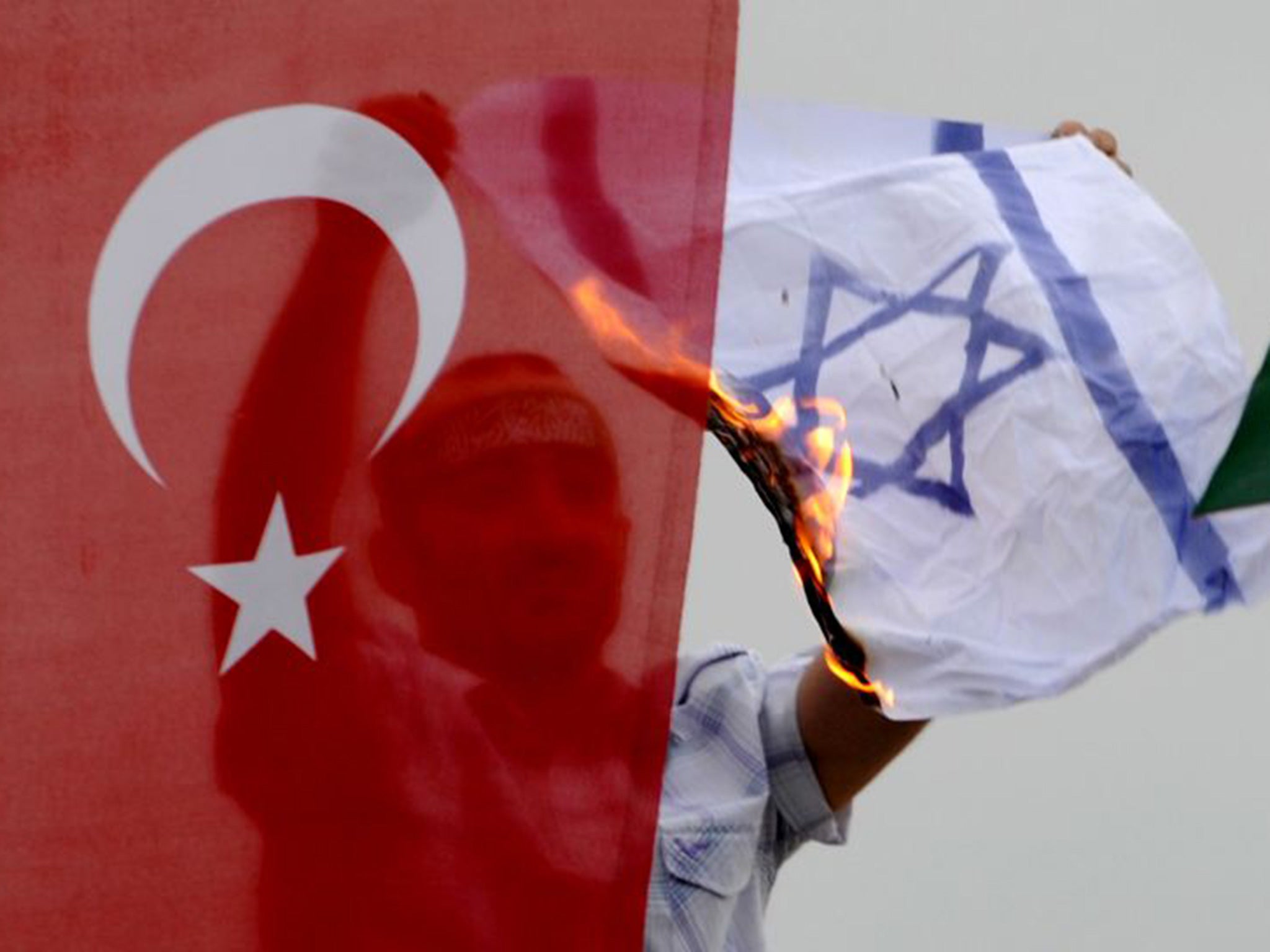 A demonstrator burns an Israeli flag a during a protest against Israel in Istanbul in 2010