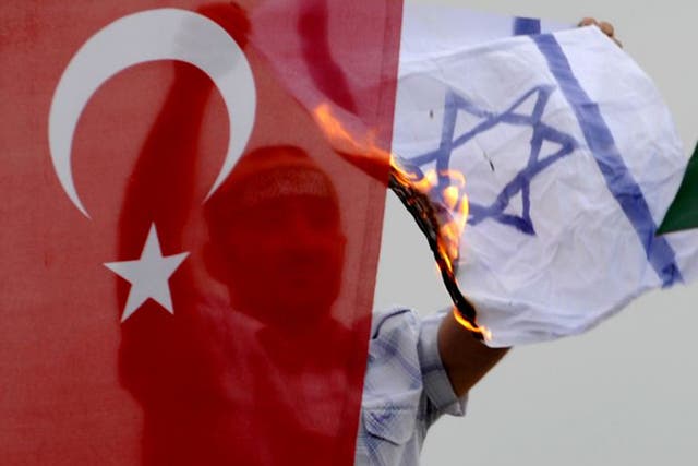 A demonstrator burns an Israeli flag a during a protest against Israel in Istanbul in 2010