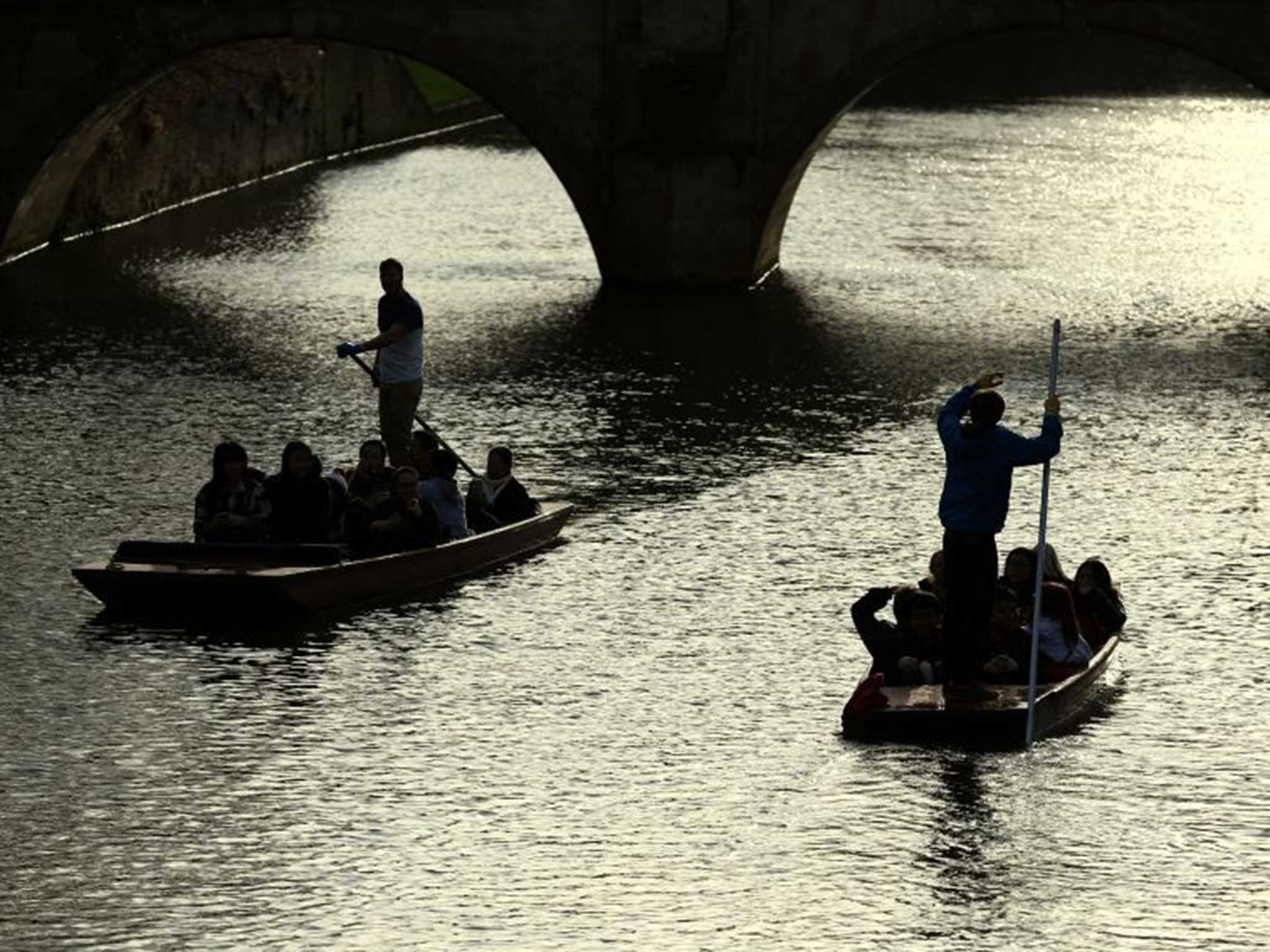 Enjoying the weather? People punt along the river in Cambridge