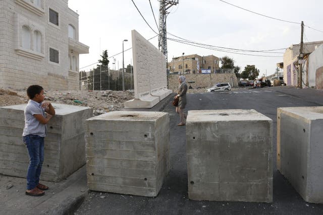 Palestinians near a checkpoint in Jebel Mukaber, east Jerusalem
