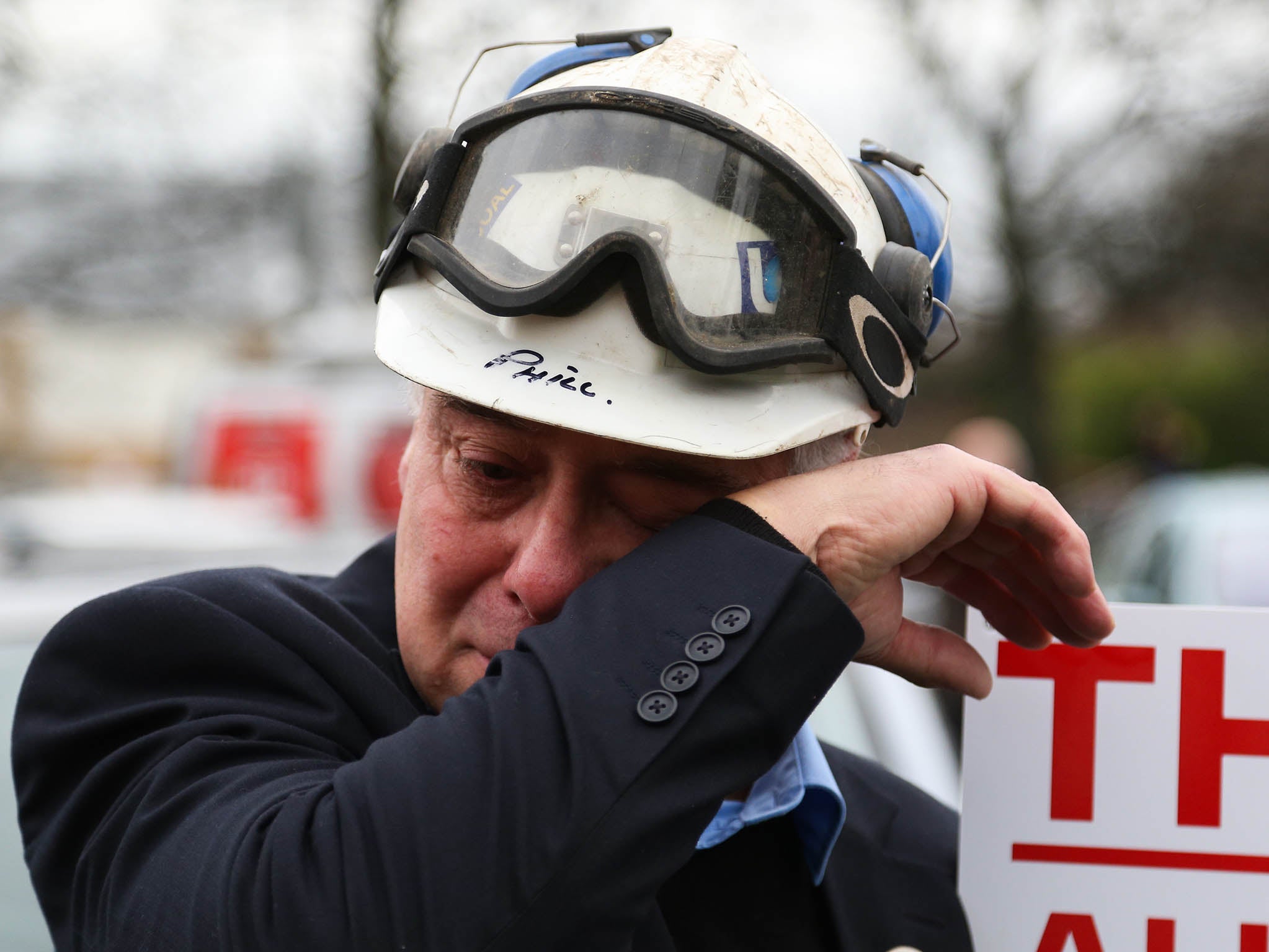 A former miner sheds a tear during a march through Knottingley, West Yorkshire, after the closure of the nearby Kellingley Colliery