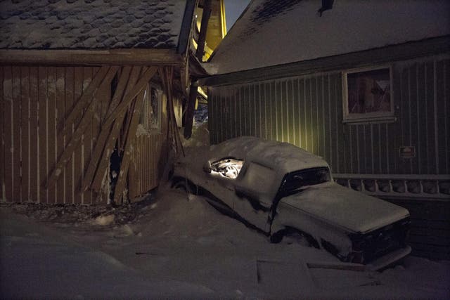 The lights still on in a car hit by the avalanche
