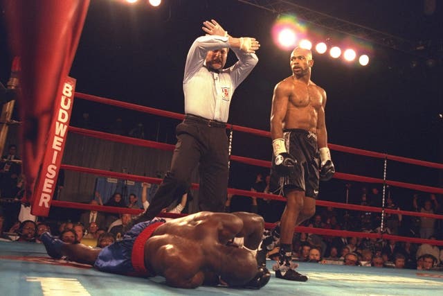 Roy Jones Jr. (right) looks on as the official counts out Bryant Brannon during the second round of a bout at Madison Square Garden in New York City, New York