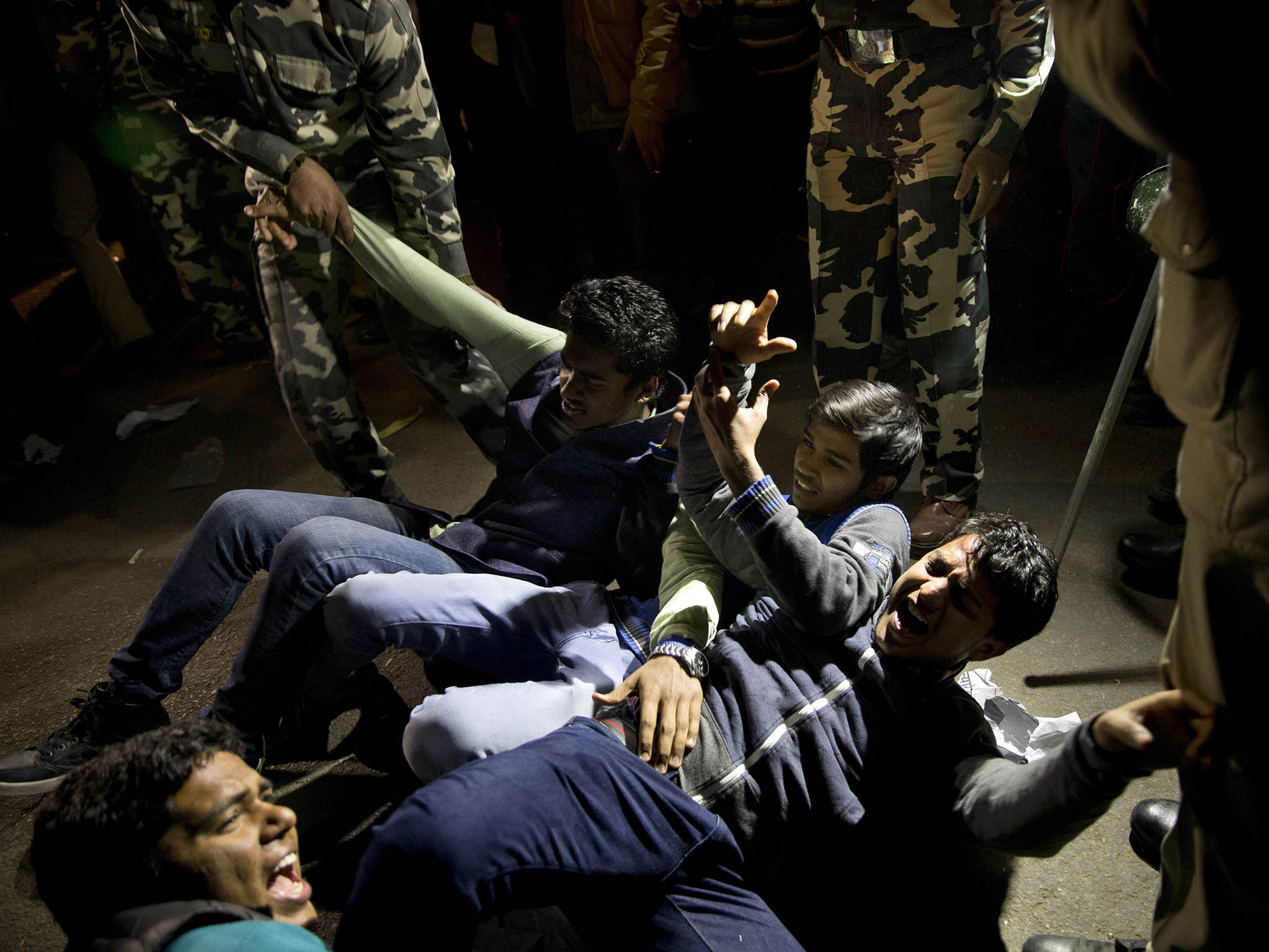 Indian youth shout slogans as they are detained by police during a protest against the release of a juvenile convicted in the fatal 2012 gang rape