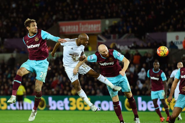 Swansea's Andre Ayew directs a header at goal