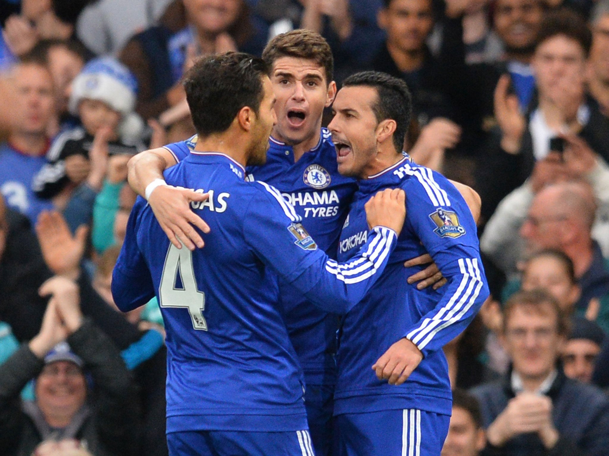 Chelsea’s Spanish midfielder Pedro, right, celebrates with Oscar, centre, and Cesc Fabregas after scoring against Sunderland at Stamford Bridge