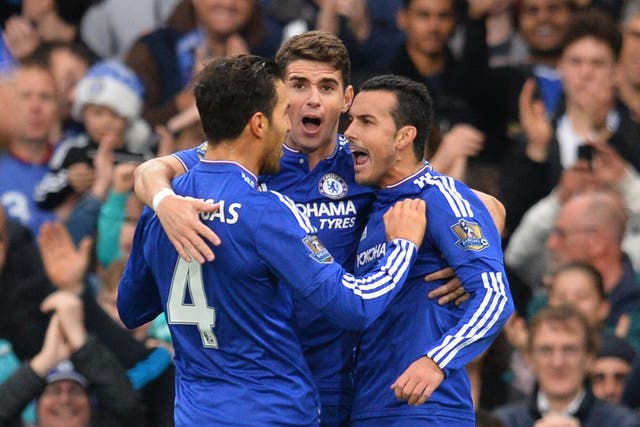 Chelsea’s Spanish midfielder Pedro, right, celebrates with Oscar, centre, and Cesc Fabregas after scoring against Sunderland at Stamford Bridge