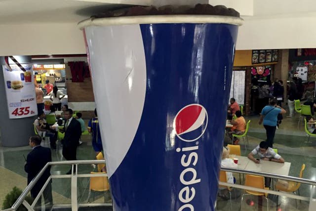 A mock giant cup of Pepsi at a shopping mall in the Venezuelan capital of Caracas on 20 December 2015