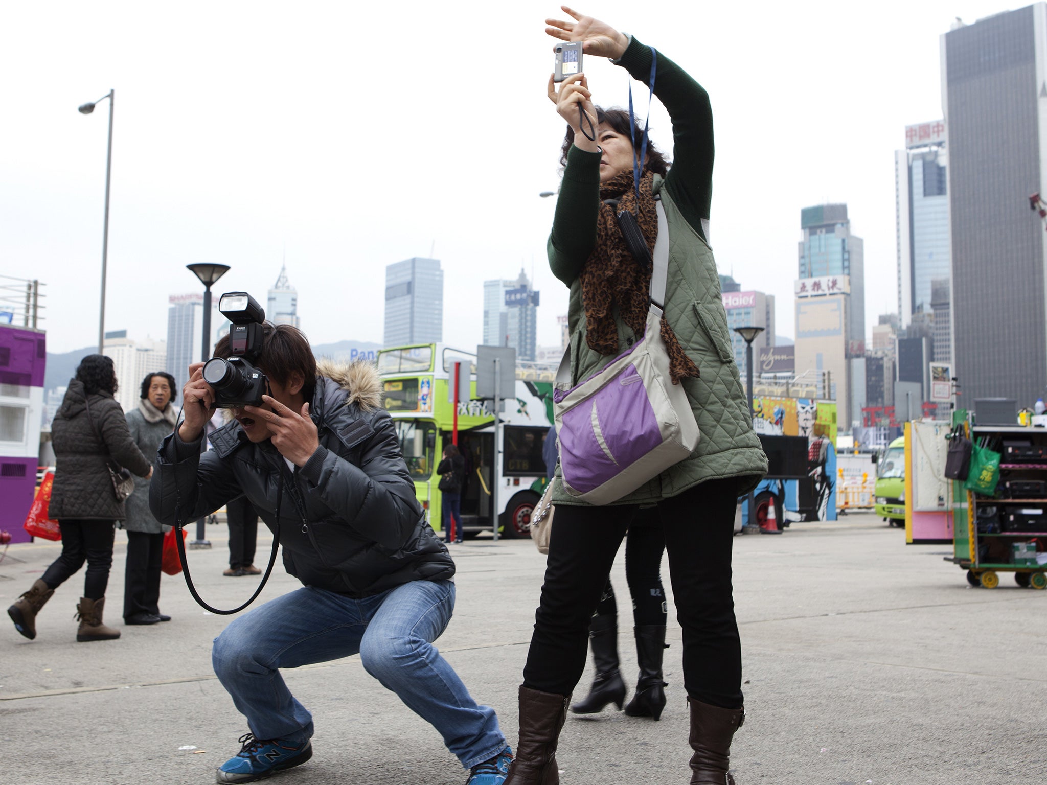 Chinese tourists take pictures in Hong Kong