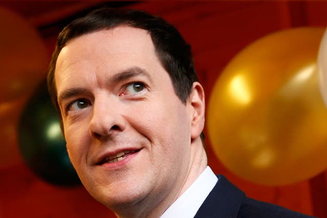 George Osborne samples chocolates during a tour of a Christmas fair at the Treasury on 4 December, 2015