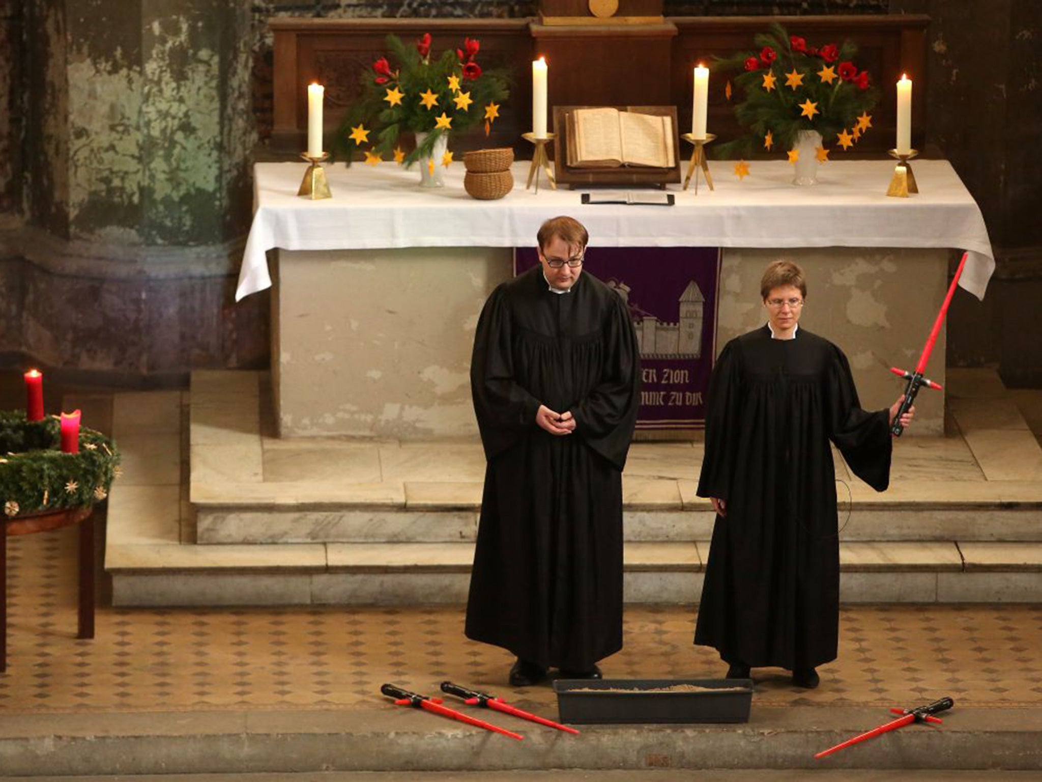 Vicars Lucas Ludewig (L) and Ulrike Garve hold a church service centered around 'Return of the Jedi' at the Zionskirche