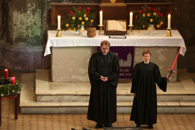 Vicars Lucas Ludewig (L) and Ulrike Garve hold a church service centered around 'Return of the Jedi' at the Zionskirche