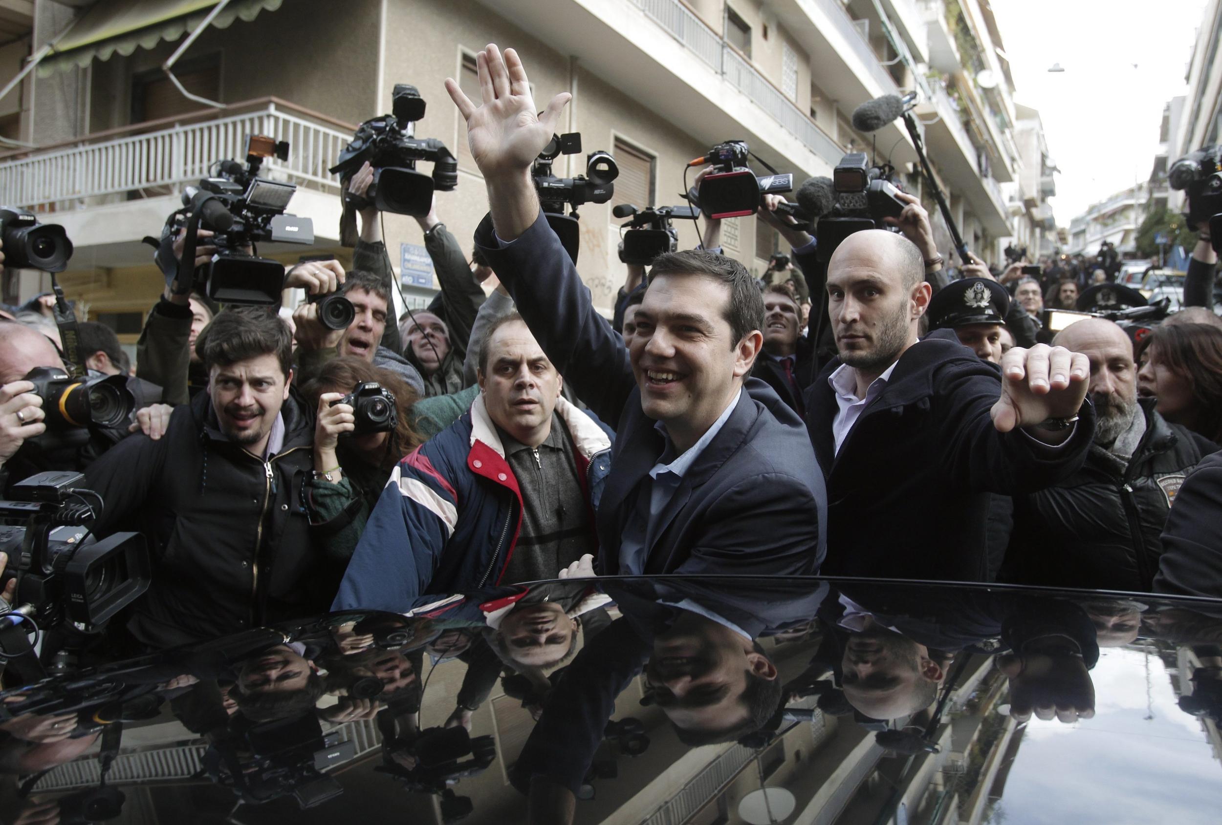 Alexis Tsipras, head of radical leftist Syriza party waves to supporters