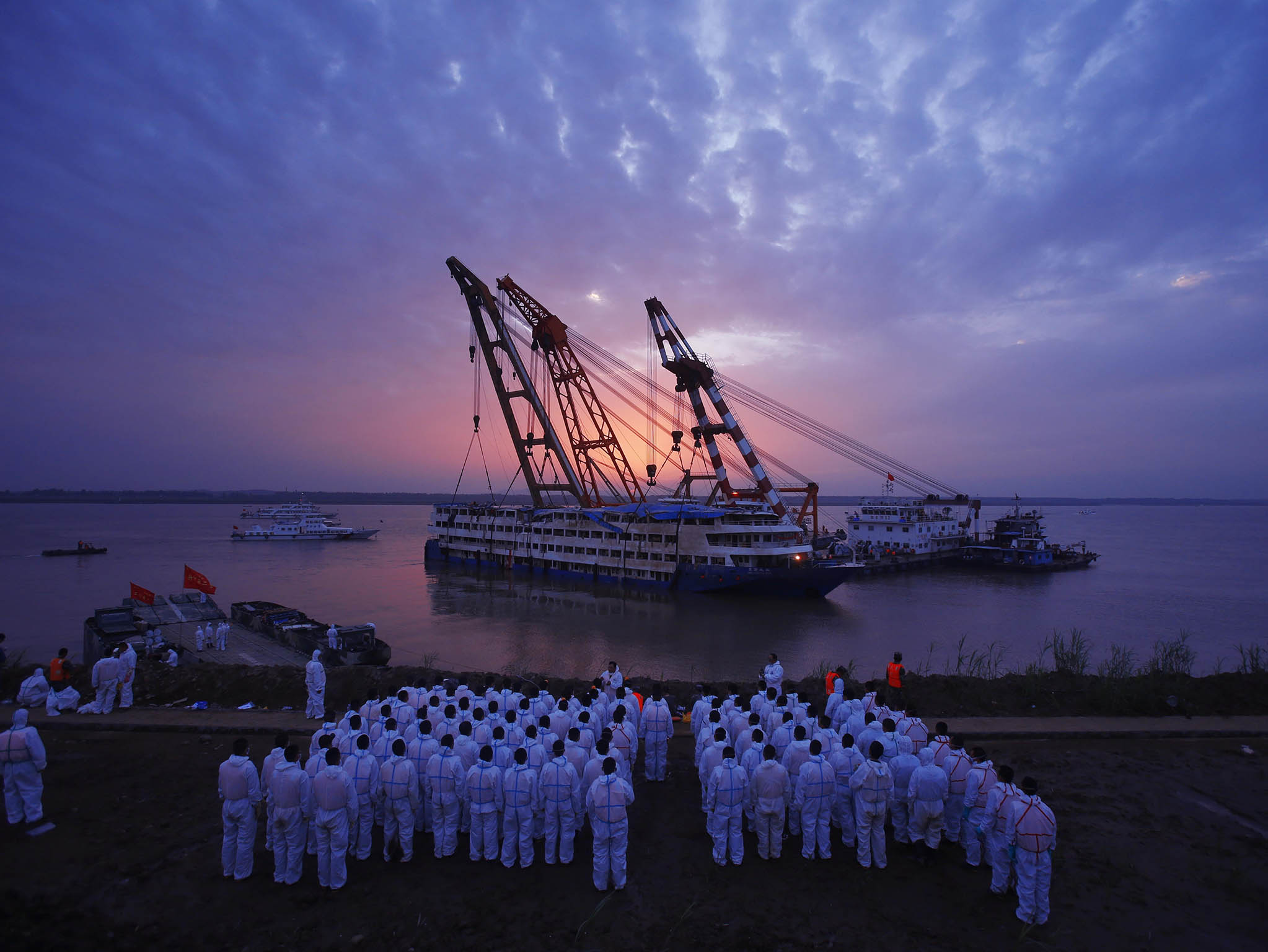 Rescuers work to raise the capsized ship Dongfangzhixing in the Yangtze River