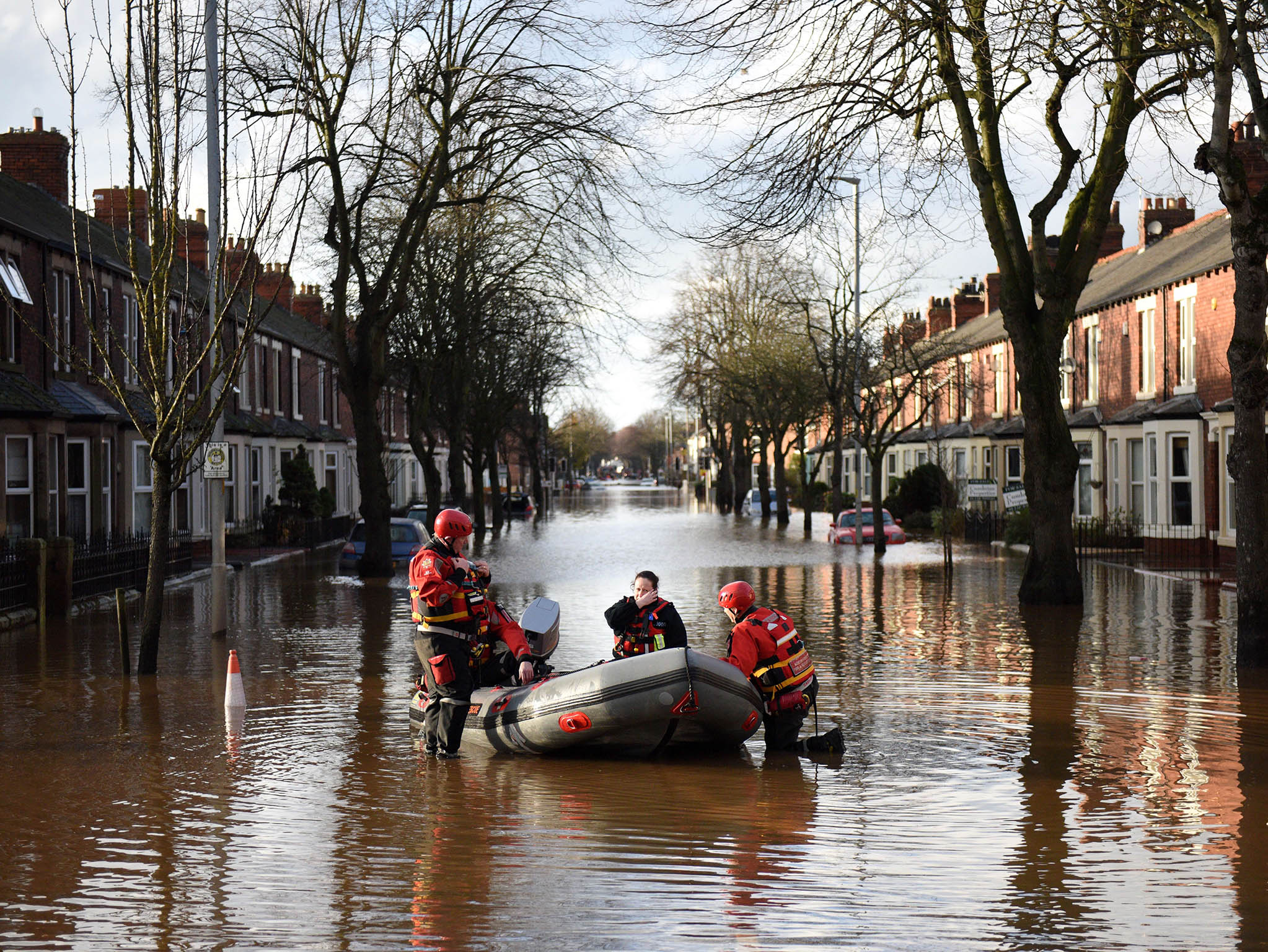 Members of the emergency services prepare to rescue residents from their flooded properties in Carlisle