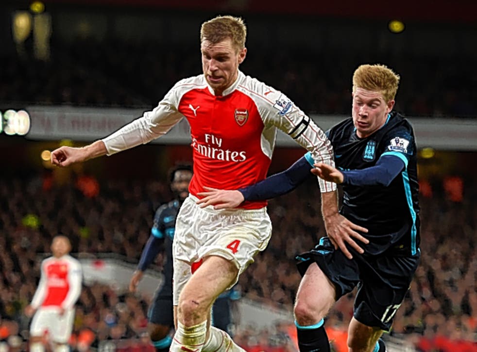 Per Mertesacker holds off Kevin De Bruyne during Arsenal’s 2-1 victory over Manchester City at the Emirates