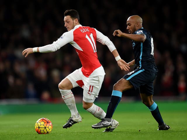 Mesut Ozil in action for Arsenal against Manchester City