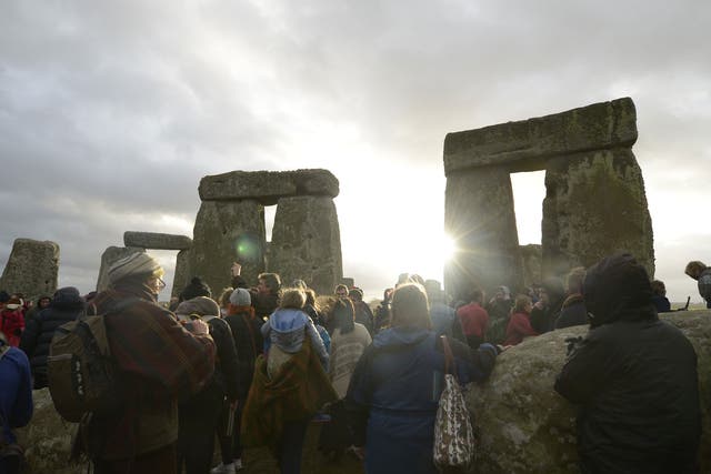 People gather at Stonehenge in Wiltshire on the Winter Solstice to witness the sunrise on the shortest day of the year