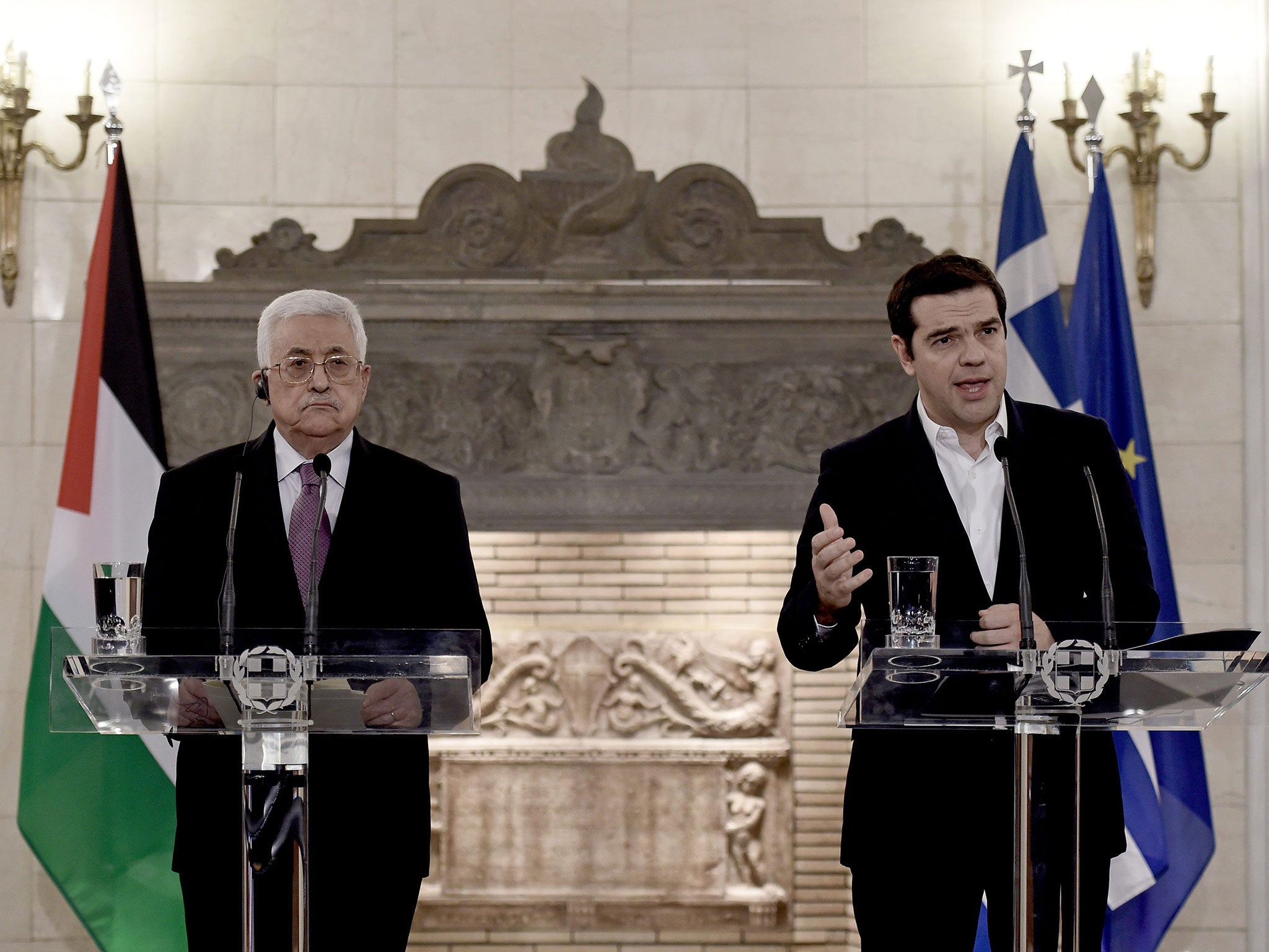 Greek Prime Minister Alexis Tsipras (R) and Palestinian president Mahmoud Abbas speak during a press conference after a meeting on December 21, 2015 in Athens