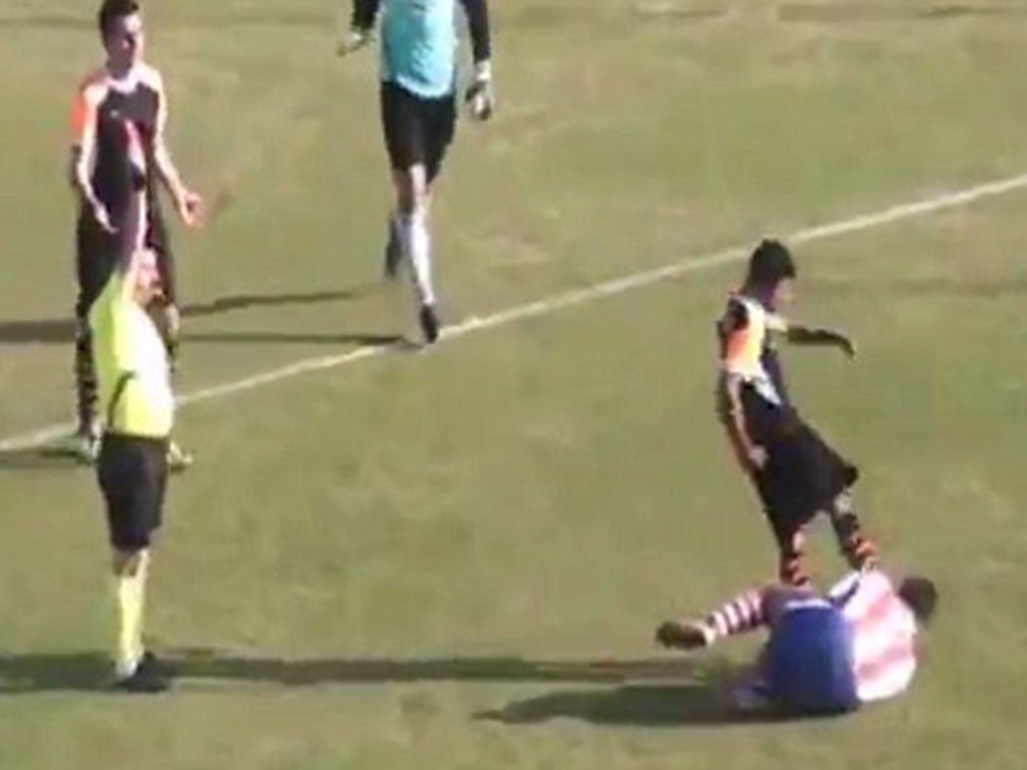 Sanayispor player Mehmet Degirmenci kicks Kayhan Karakas of Dallicaspor in the head