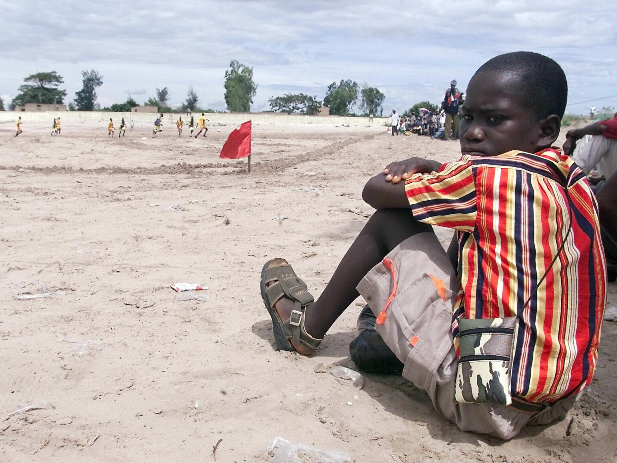 A teenager in Senegal watches a football match