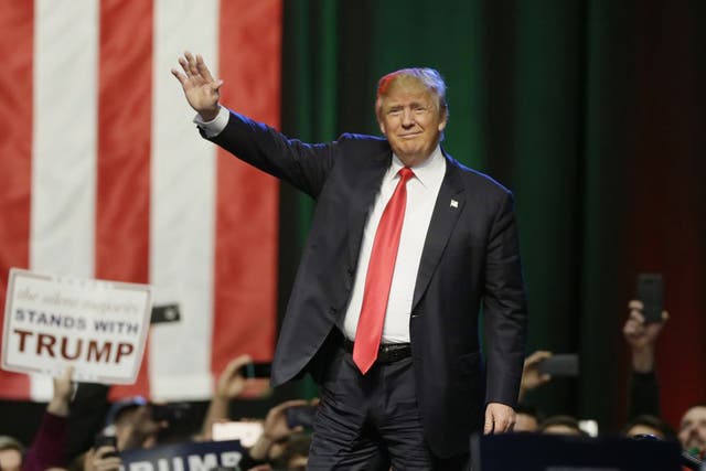 Donald Trump acknowledges the crowd before addressing supporters at a campaign rally, Monday, 21 December 2015